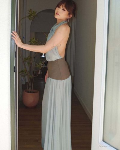 Karen Fukuhara in a flowing light blue gown with brown accents.