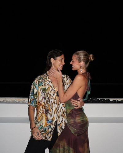 Kari Riley wearing a rainbow-colored bikini with geometric patterns.