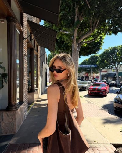 Kari Riley wearing a colorful two-piece swimwear by the shore.