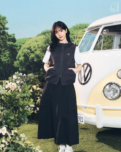 Karina in a white lightweight jacket paired with trousers