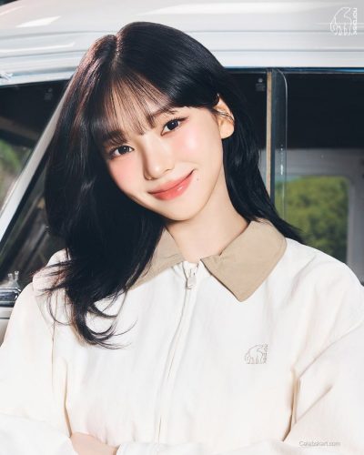 Karina in a modern white outfit with a playful touch