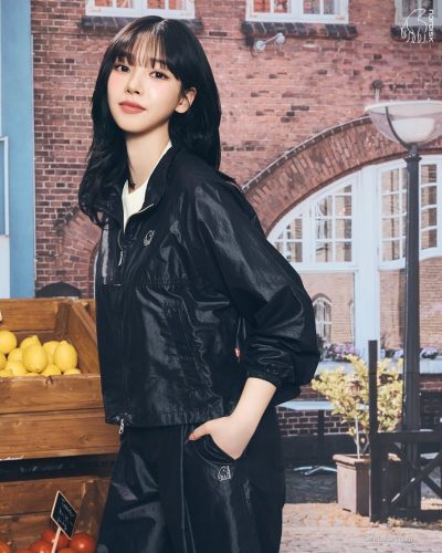 Karina with a fashionable cap and light white attire