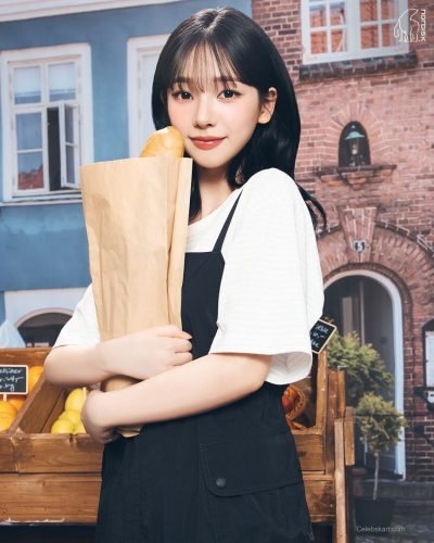 Karina in a lightweight white jacket and casual white top