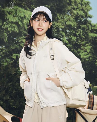 Karina in a modern white outfit with a playful touch