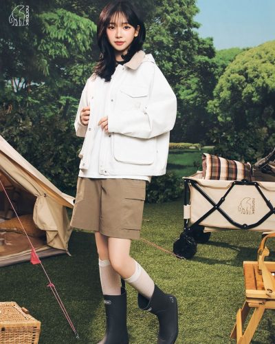 Karina with a fashionable cap and light white attire