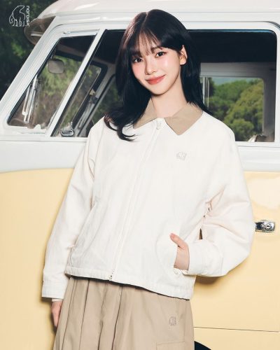 Karina in a lightweight white jacket and casual white top