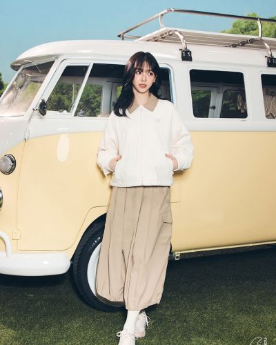 Karina in a fresh white top and fashionable cap
