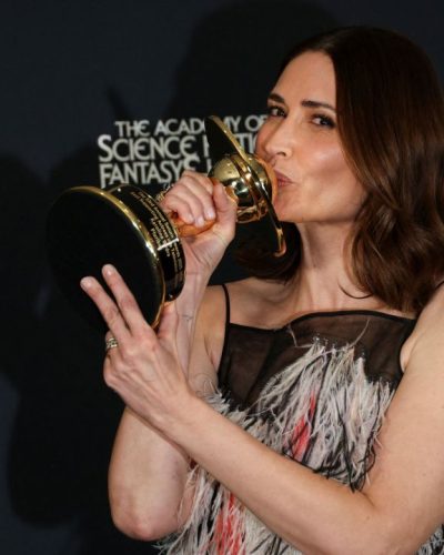 Karolina Wydra chic gown with feather accents and soft waves