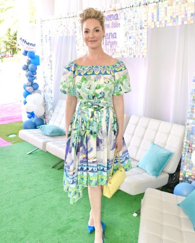 Katherine Heigl colorful floral dress with stylish yellow handbag.