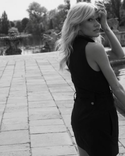 Katherine McNamara in a black fitted dress with modern flair