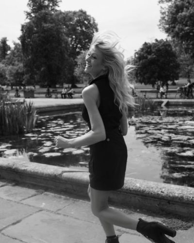 Katherine McNamara in a minimalist black dress with high neckline