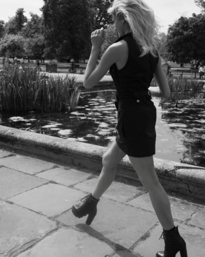 Katherine McNamara wearing a sleek black dress and trendy footwear