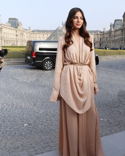 Kelly Piquet in flowing floor-length gown with draped design