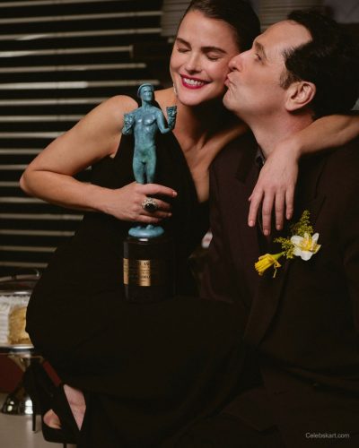 Keri Russell in a black gown with bold red lips