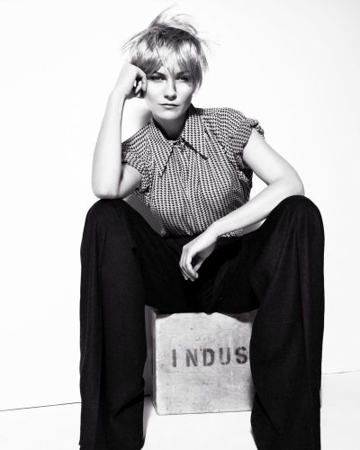 Kirsten Dunst black lace bra with edgy leather skirt.