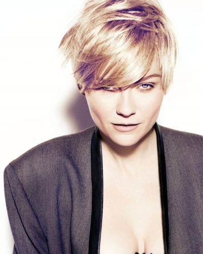 Kirsten Dunst black leather skirt paired with fitted jacket.