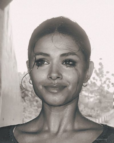 Komal Ilsanker in modern white gown with figure-hugging silhouette