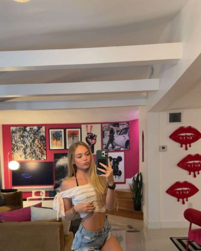 Kyla Dodds in navy floral bikini enjoying beach day