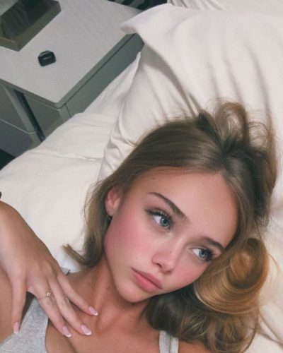 Kyla Dodds in navy floral swimwear with beach backdrop