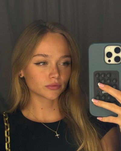 Kyla Dodds in playful floral bikini with chic accessories