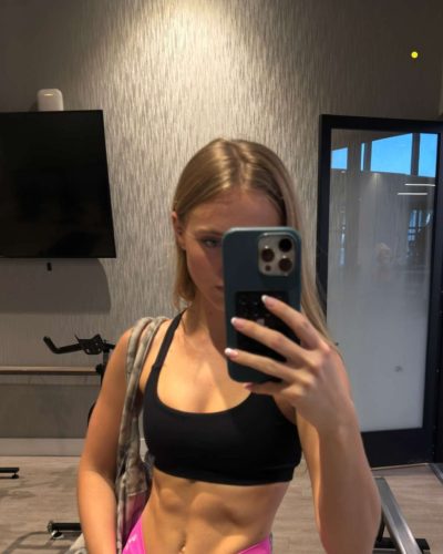 Kyla Dodds in navy floral bikini enjoying beach day