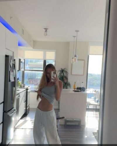 Kyla Dodds in navy bikini with floral patterns and sunglasses