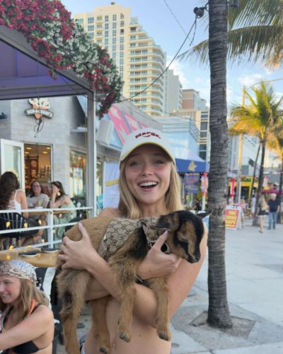 Kyla Dodds in navy floral swimwear with beach backdrop