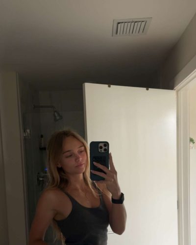 Kyla Dodds in vibrant floral bikini by the ocean