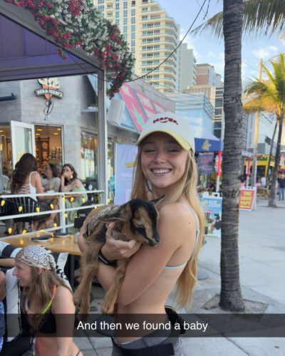 Kyla Dodds in navy bikini with floral patterns and sunglasses