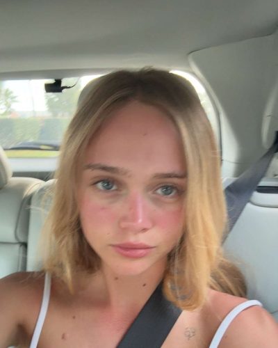 Kyla Dodds wearing casual denim shorts and red bikini