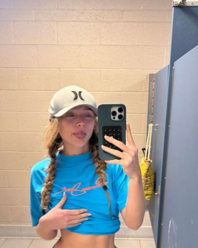 Kyla Dodds in black jacket and red swimwear