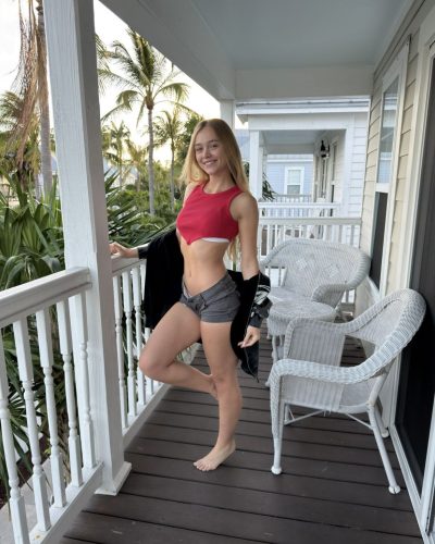 Kyla Dodds with playful vibe in red bikini and jacket