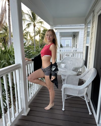 Kyla Dodds in vibrant red bikini and black jacket