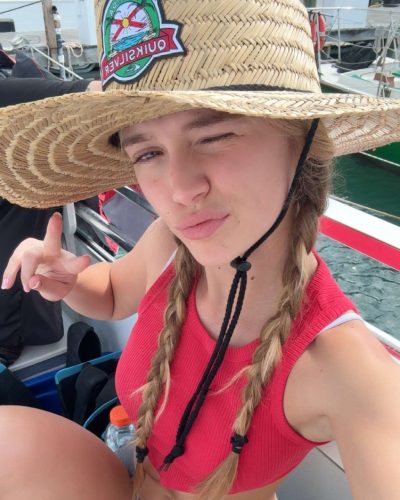 Kyla Dodds wearing casual denim shorts and red bikini