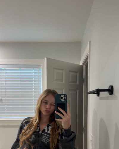 Kyla Dodds in casual beach style with black jacket