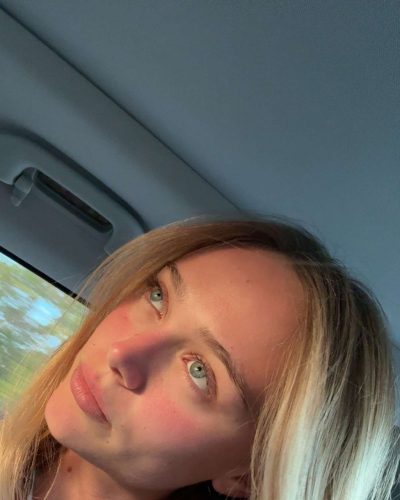 Kyla Dodds in casual beach style with black jacket