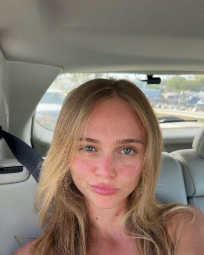 Kyla Dodds with playful vibe in red bikini and jacket