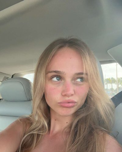 Kyla Dodds in vibrant red bikini and black jacket