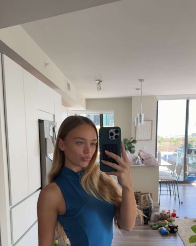 Kyla Dodds in relaxed blue top complemented by black leggings.