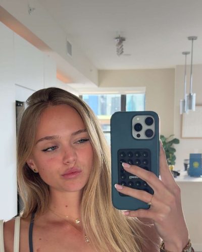 Kyla Dodds with long, flowing hair and delicate necklace.