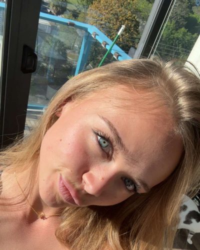 Kyla Dodds in a graphic tee featuring deep red accents.