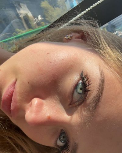 Kyla Dodds with a vintage graphic crop top and casual shorts.