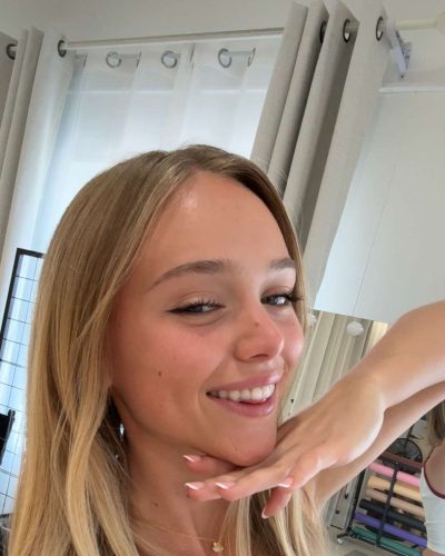 Kyla Dodds wearing a white crop top with vintage graphic design.