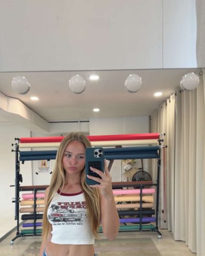 Kyla Dodds in a graphic tee featuring deep red accents.