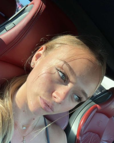 Kyla Dodds wearing high-waisted denim shorts for summer style.