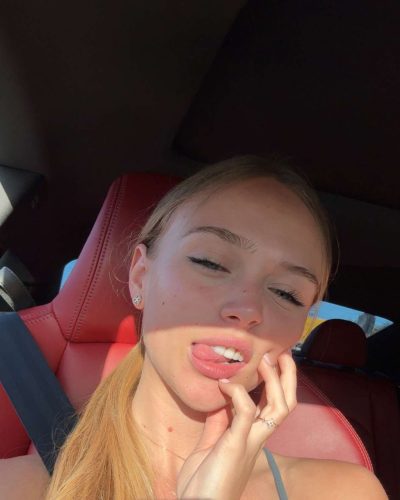 Kyla Dodds accessorized with a delicate necklace and casual wear.