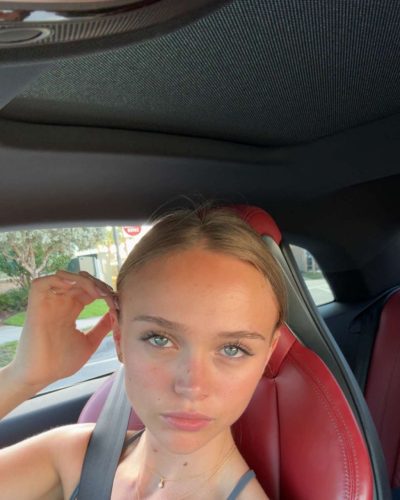 Kyla Dodds wearing a graphic tee and high-waisted shorts.