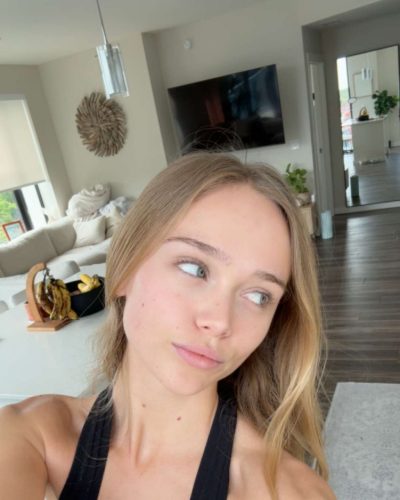 Kyla Dodds black strapless top with light blue flower jeans