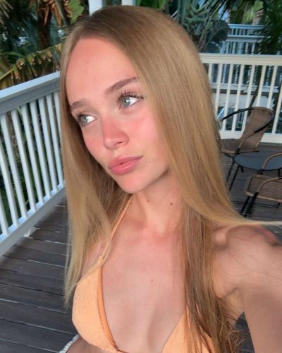 Kyla Dodds in blue bikini surrounded by friends.