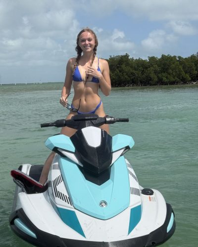 Kyla Dodds in blue bikini soaking up the sun.